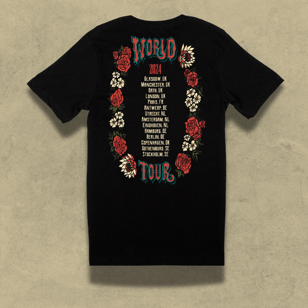 Black t-shirt with a colorful ’World Tour’ design featuring floral elements and tour dates.