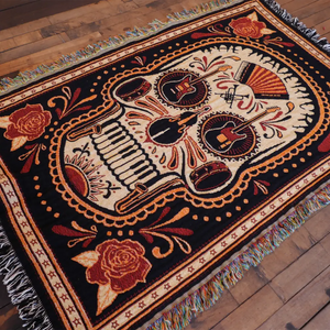 Woven blanket with musical skull design.