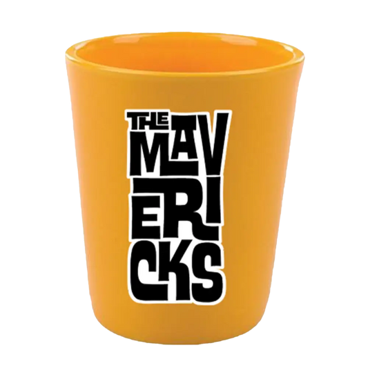 Bright orange shot glass with ’THE MAVERICKS’ printed in black lettering.