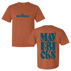 Rust-colored t-shirt with teal ’The Mavericks’ text on front and stylized ’Mavericks’ on back.